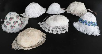 Mainly 19th Century Bonnets comprising three Irish crochet examples woven with raised flower