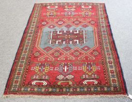 North West Persian Kurdish Rug, the blood red field with pale indigo central panel surrounded by