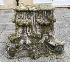 A Weathered Stone Corbel, in the form of a corinthian column cap, 104cm by 49cm by 76cm