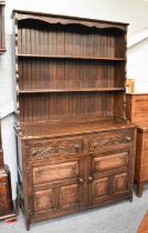 A 20th Century Carved Oak Dresser and Rack, 124cm by 45cm by 200cm