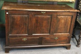 An 18th Century Oak Mule Chest, with three moulded panels over two base drawers, raised on bracket