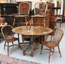 A 20th Century Oak Gate Leg Table, 133cm by 107cm by 74cm, and a set of four Windsor side chairs