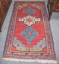 Hamadan Rug, the blood red field with three stepped medallions framed by spandrels and meandering