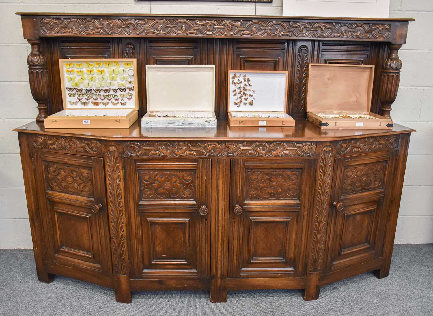 A Waring & Gillow Oak Sideboard, the super structure with carved frieze supported by fluted and