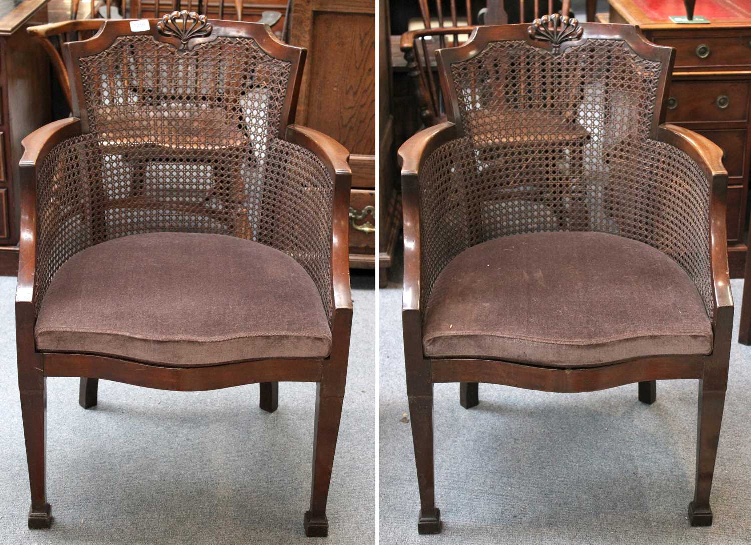 A Pair of 1920s Caned Armchairs, with foliate carved crest rail