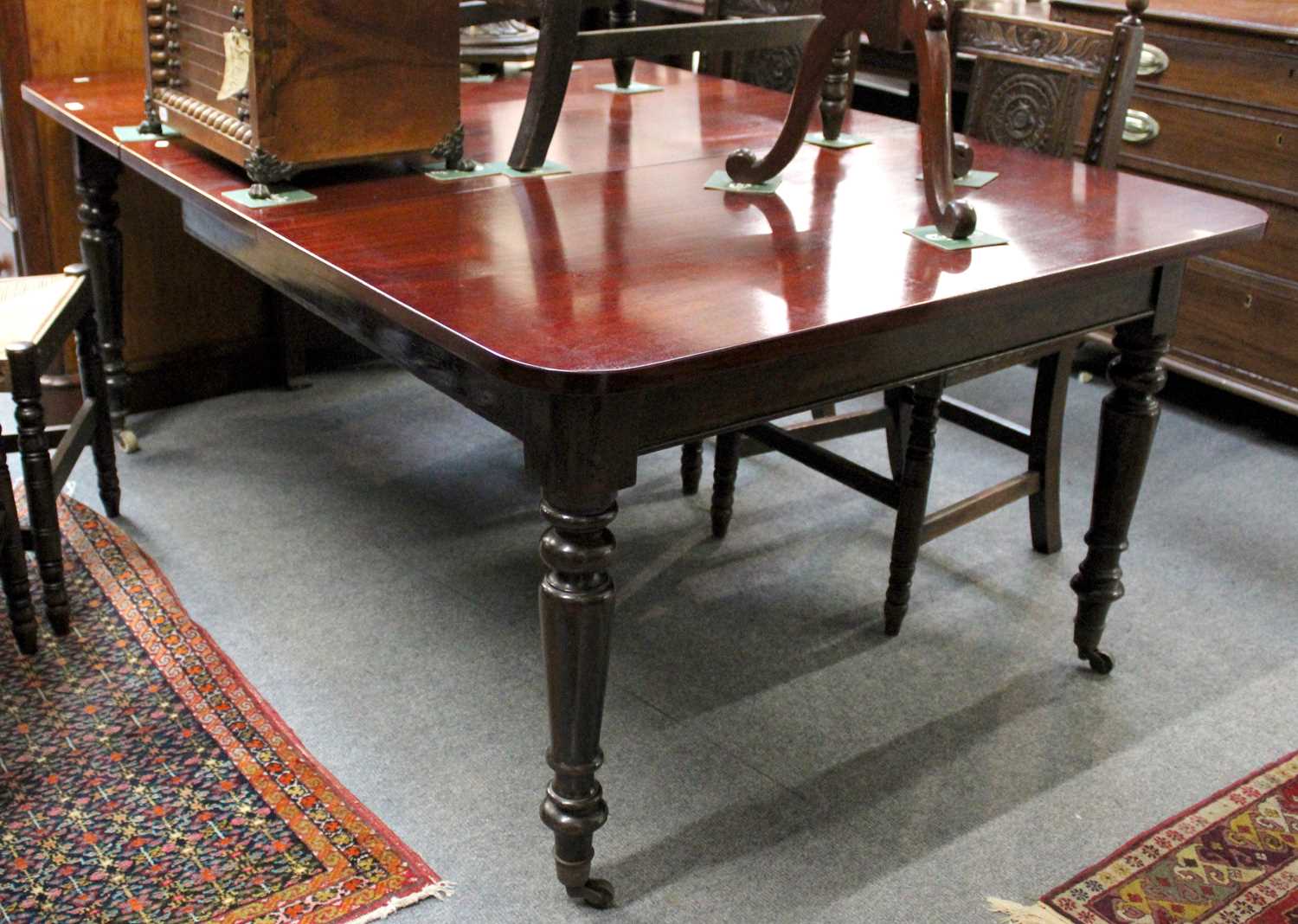 A Victorian Mahogany Dining Table, with one additional leaf on turned legs and castors, 180cm by - Image 5 of 5