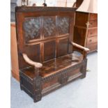 An 18th Century Carved Oak High Backed Box Settle, 136cm by 48cm by 146cm