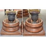 A Pair of Cast Metal Garden Urns, with flared rims and foliate decoration on square plinth bases,