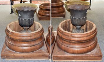A Pair of Cast Metal Garden Urns, with flared rims and foliate decoration on square plinth bases,