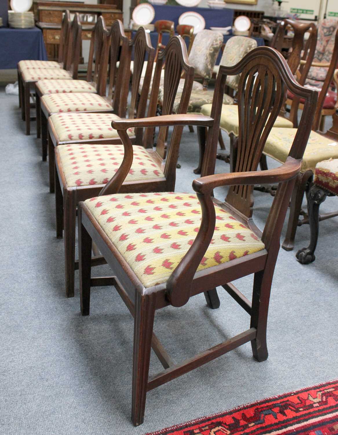 A Set of Seven George III Mahogany Dining Chairs, including one carver