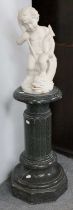 A Marble Figure of a Putto and Dolphin, 42cm high on a varigated green marble column, 61cm high (