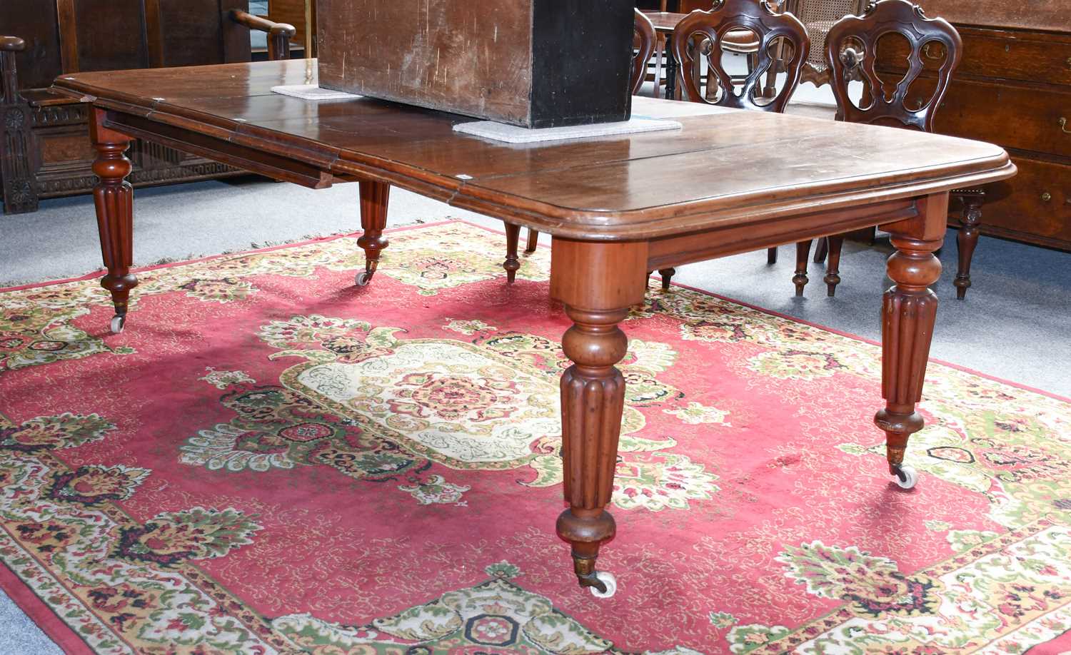 A Victorian Mahogany Wind-Out Extending Dining Table, with four leaves, the moulded top raised on