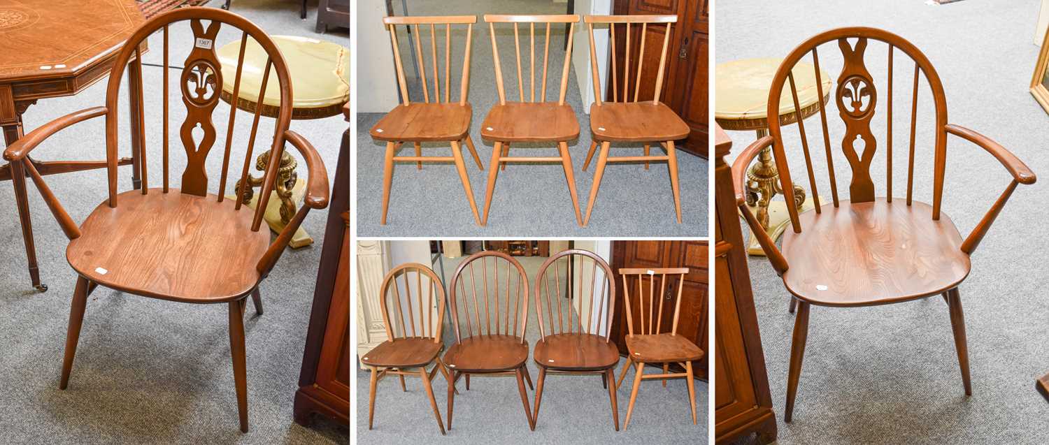 A Set of Five Ercol Elm Hoop Back Dining Chairs, including two carvers; together with a set of