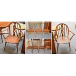 A Set of Five Ercol Elm Hoop Back Dining Chairs, including two carvers; together with a set of