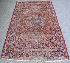 Mashad Rug, the raspberry field centred by a sky blue flowerhead medallion, framed by spandrels