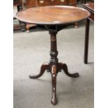 A George III Mahogany Circular Tripod Table, dished top on gun barrell support and pad feet, 64cm