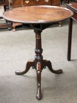 A George III Mahogany Circular Tripod Table, dished top on gun barrell support and pad feet, 64cm