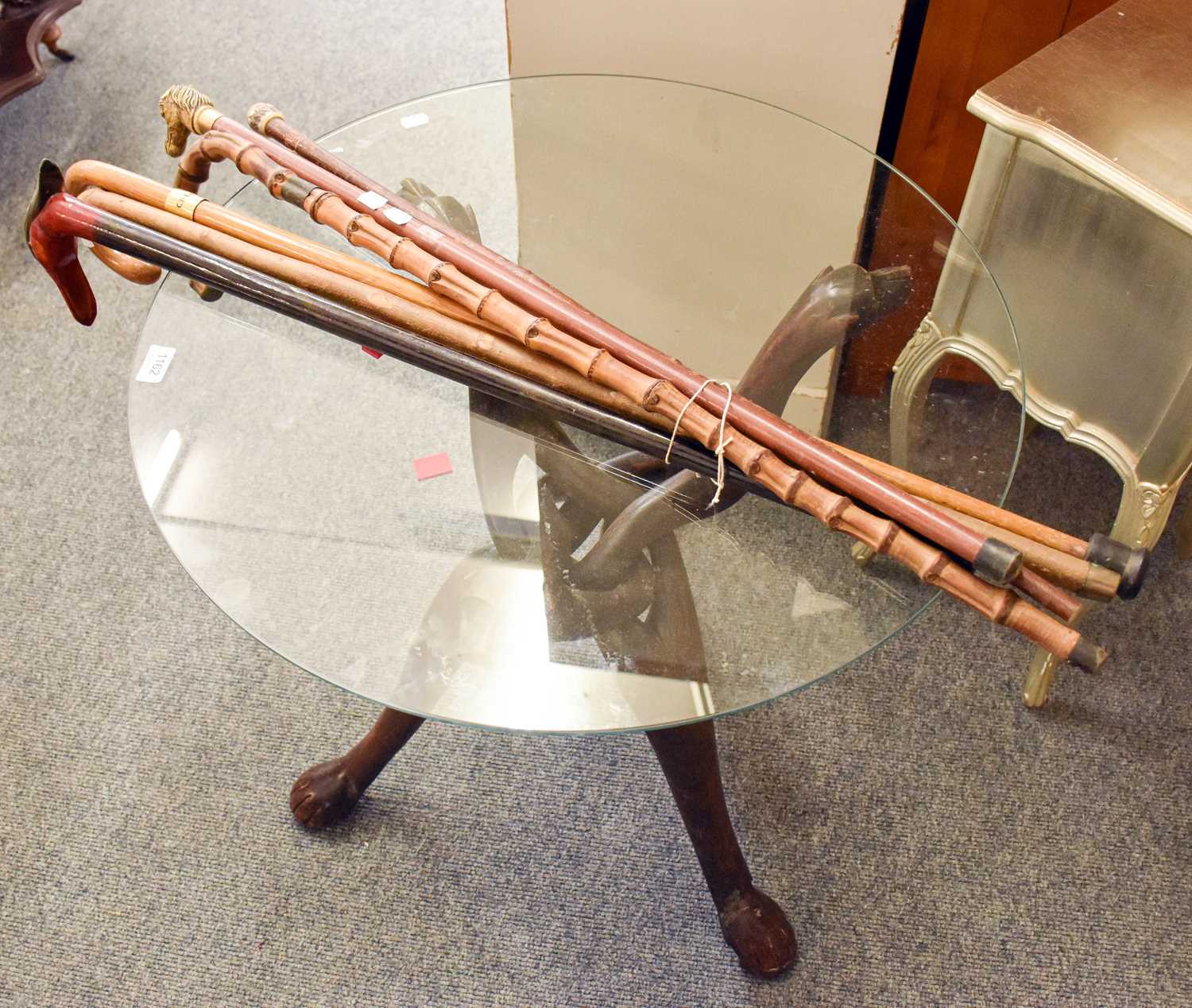 A Zoomorphic Interlocking Folding Stand, with dogs head terminals and paw feet, later glass top, - Image 2 of 2