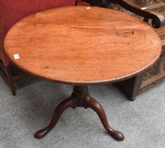 A George III Mahogany Tripod Table, on gun barrell supports and pad feet, 85cm by 70cm