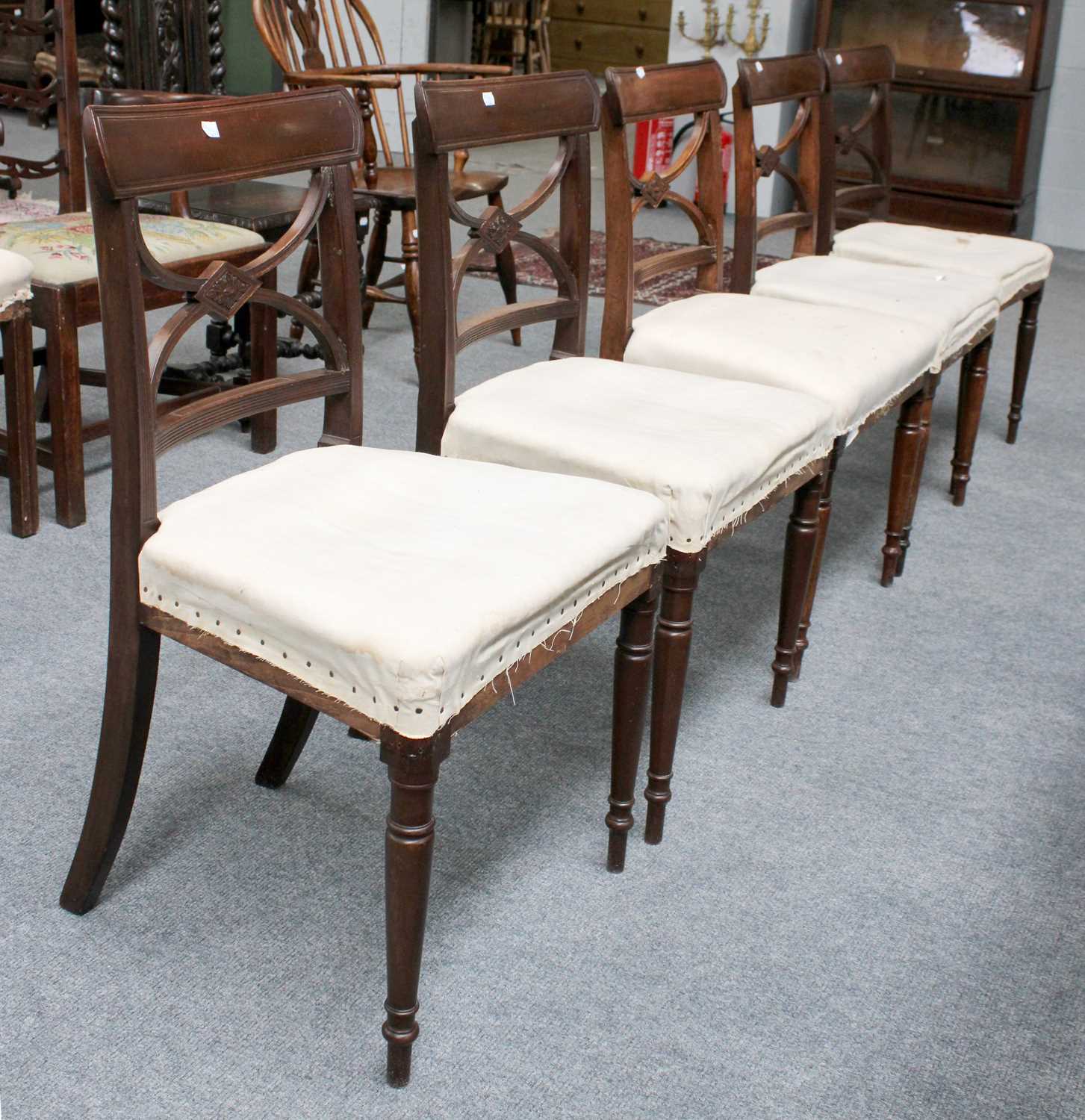 A Set of Five Regency Mahogany Dining Chairs, each with lozenge and shape strap backs