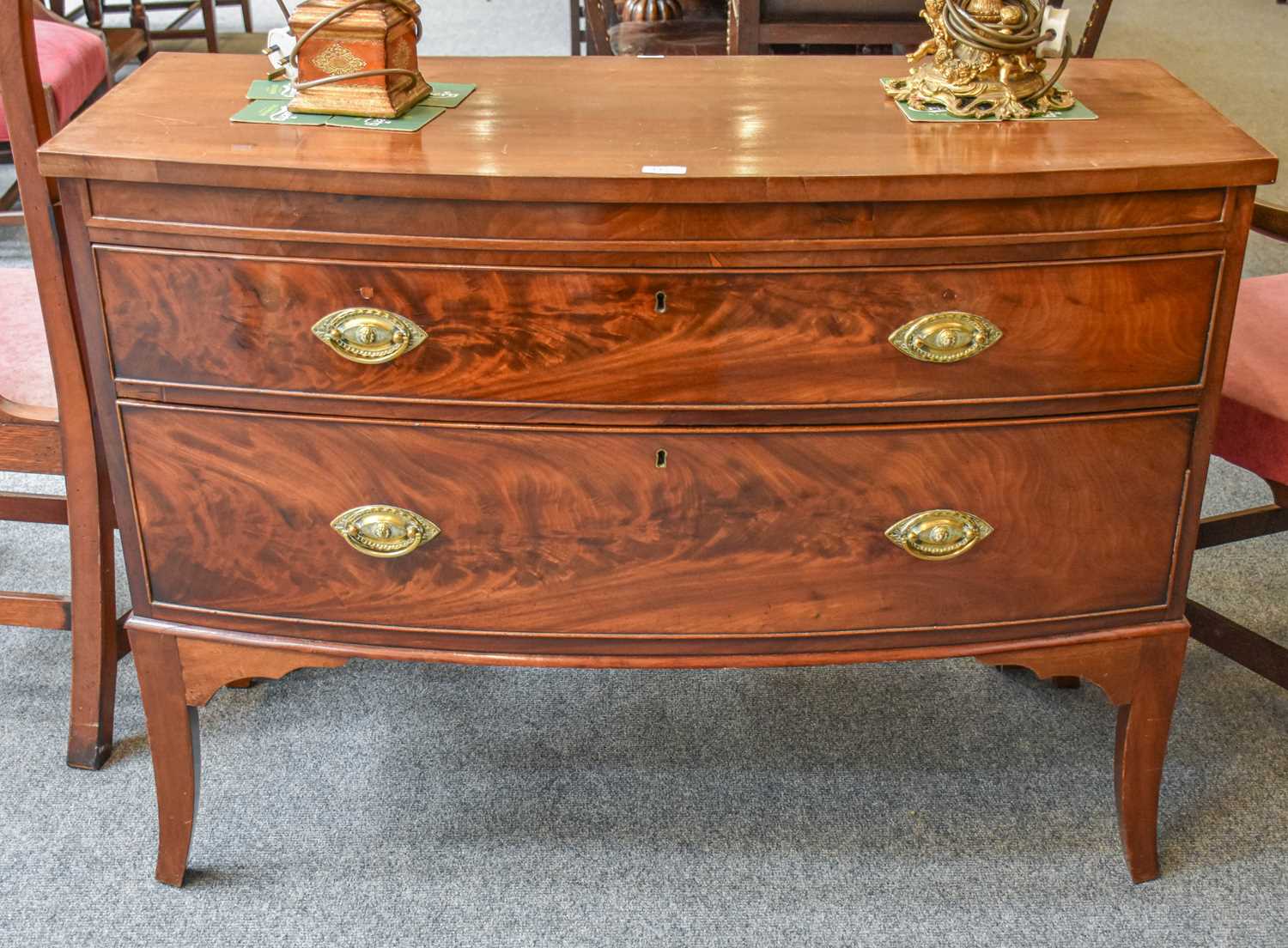 A Georgian Mahogany Bow Front Two Drawer Chest, 114cm by 52cm by 85cm; together with a mid 20th