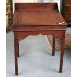 A 19th Century Mahogany Clerks Desk, with hinged slant top, pierced spandrels and canted square