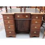 A 19th Century Oak Lined, Cross Banded Mahogany Desk, the leather inset inverted break front top