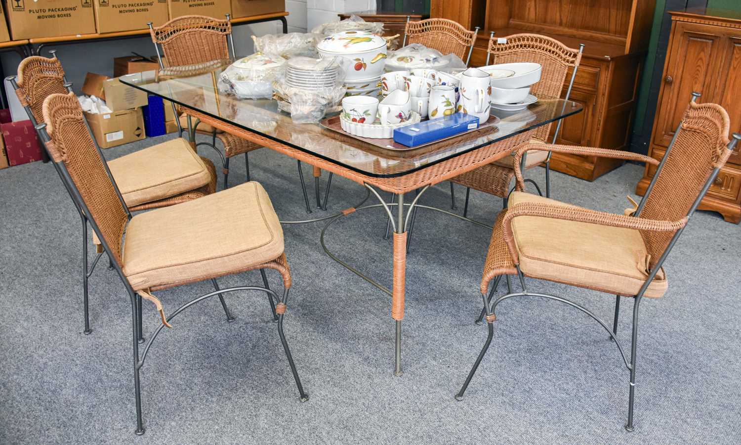 A Metal and Wicker Glass Topped Dining Table and Six Matching Chairs, including two carvers (7)