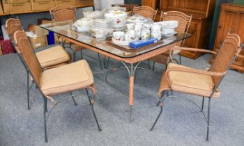 A Metal and Wicker Glass Topped Dining Table and Six Matching Chairs, including two carvers (7)