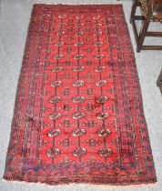 Baluch Rug, the crimson field with columns of quartered güls framed by multiple borders,180cm by
