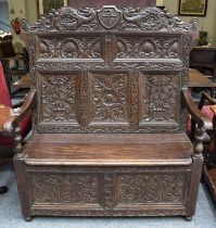 An Late/Early 19th Carved High Back Settle, with central crest amongst zooamorphic carvings over