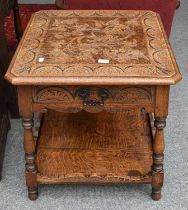 A 20th Century Carved Oak Two Tier Lamp Table, fitted with a drawer, decorated with lunette carving,