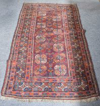 Baluch Rug of Turkmen Design, the aubergine field with two columns of octagons framed by