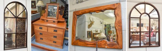 An Arts and Crafts Walnut Dressing Chest, two arched wall mirrors, largest 74cm by 105cm, and a