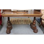 A Victorian Rosewood Library Table, the moulded rectangular top with canted corners on turned