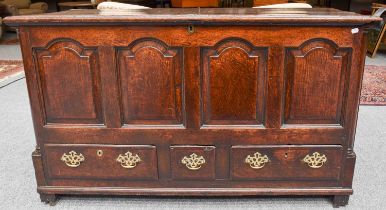 An 18th Century Oak Mule Chest, with four arched moulded panels flanked by quarter columns, and