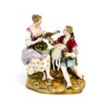 A Meissen Porcelain Figure Group of a Shepherd and Shepherdess with Ewe, 19th century, both seated