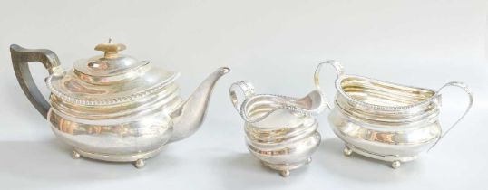 A Three-Piece Edward VII Silver Tea-Service, by Charles Stuart Harris, London, 1903, in the George