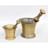 A Bronze Pestle and Mortar, 18th century, with double side pestle having knopped handle, 19cm