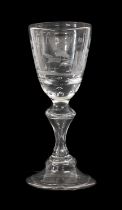 A German Wine Glass, circa 1740, the rounded funnel bowl engraved with a bird sitting on a branch,