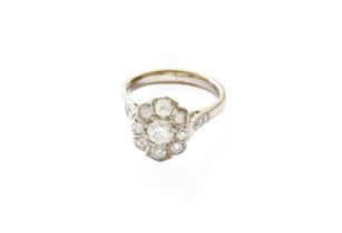 A Diamond Cluster Ring, the round brilliant cut diamond within a border of old cut diamonds, in