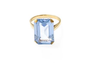 A 9 Carat Gold Synthetic Spinel Ring, the emerald-cut synthetic spinel in a yellow claw setting,