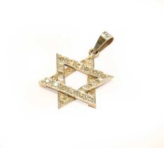 A Diamond Star Pendant, stamped '18K', length 2.9cm Gross weight 2.9 grams.