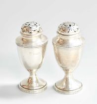 A Pair of Silver pepperettes and a cream jug