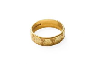 An 18 Carat Gold Textured Band Ring, finger size Q1/2 Gross weight 5.3 grams.