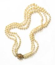 A Graduated Three Row Cultured Pearl Necklace, knotted to a knot motif clasp set throughout with a