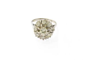A Diamond Cluster Ring, the central raised round brilliant cut diamond within a border of round