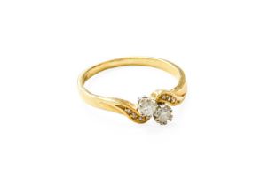 An 18 Carat Gold Diamond Two Stone Twist Ring, the round brilliant cut diamonds in white claw