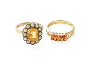 A Citrine and Split Pearl Cluster Ring, the oval cut citrine within a border of split pearls, in