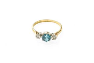 A Blue Zircon and Diamond Three Stone Ring, the round cut blue zircon in a white claw setting